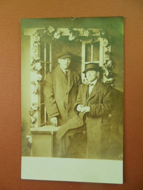 Image for Real Photo Postcard Men in in Overcoats Posing Under Trellis