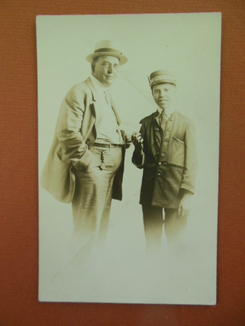 Image for Real Photo Postcard Boy Dressed as Railroad Conductor Taking Man's Ticket, Pittsburg, PA