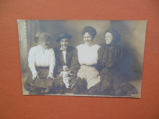 Image for Real Photo Postcard Smiling Group Young Man with Two Dolls
