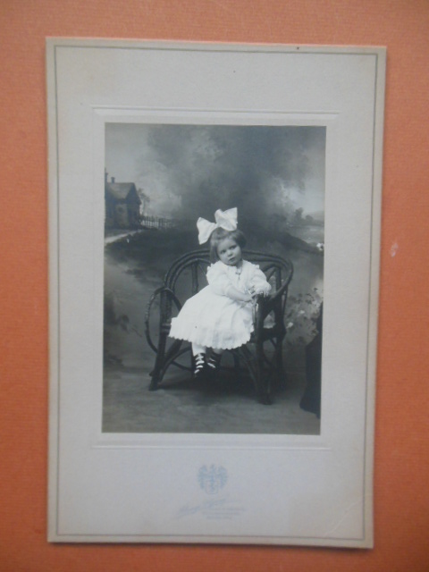 Image for Photograph Little girl with Big Hair Bow Sitting on Bench (1910 Alonzo P. Young)