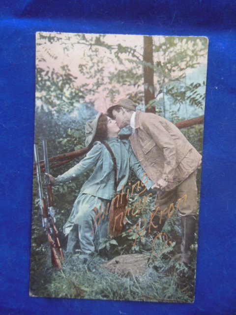 Image for Postcard Hunting Near Akron, Ohio Couple Kissing, Rifles Next to Fence (1910)