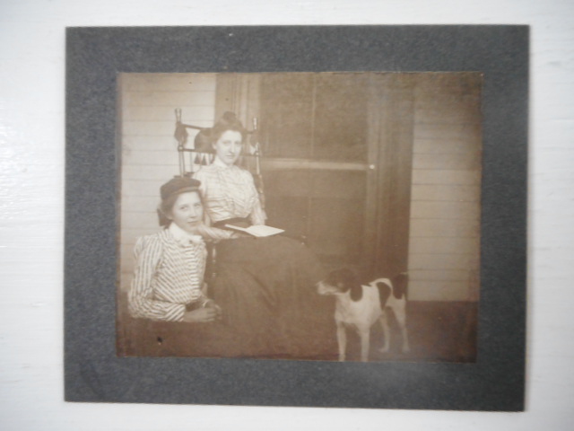 Image for Photograph; Young Girl with Older Woman Readng on Porch with Dog